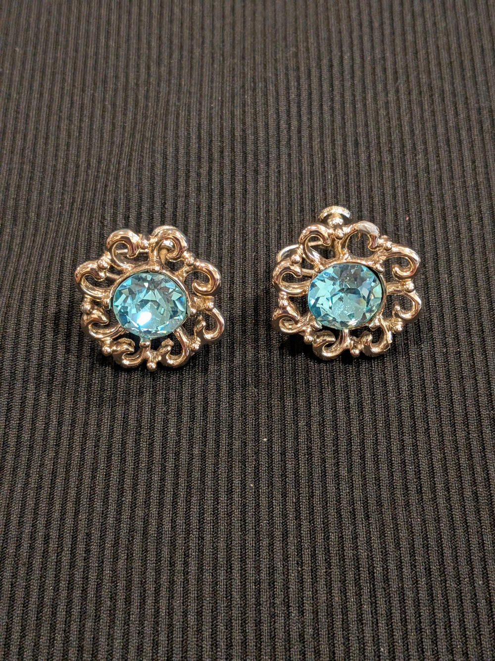 B$3: Gold-Tone Floral Clip On Earrings with Aqua Blue Crystal